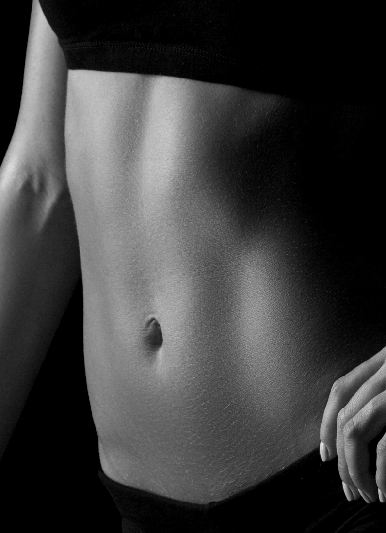 Closeup of flat stomach in black and white